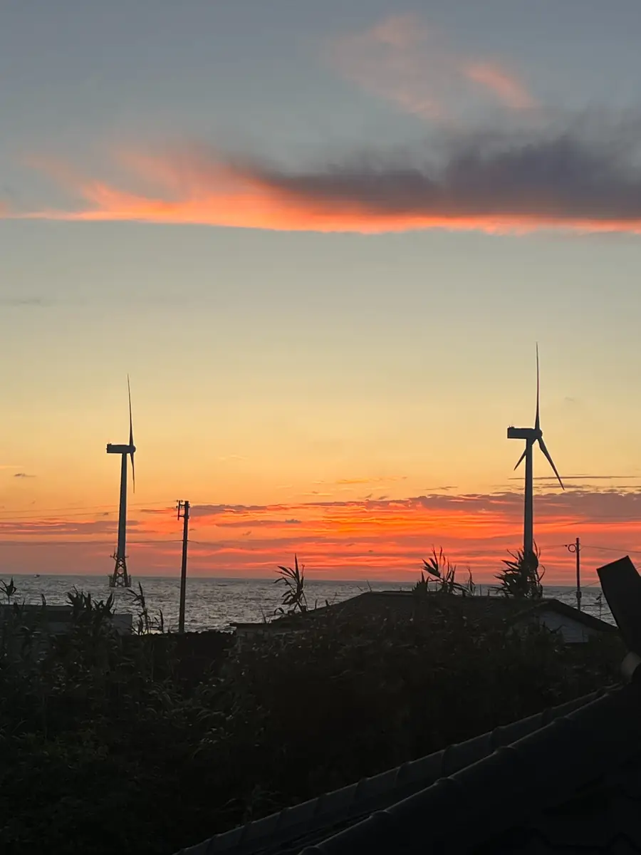 Sunset beside wind turbines on the coast near Panpo Port