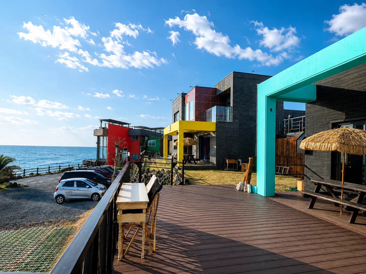 Colorful exterior and deck at the Witch’s Hill Jeju stay by the sea
