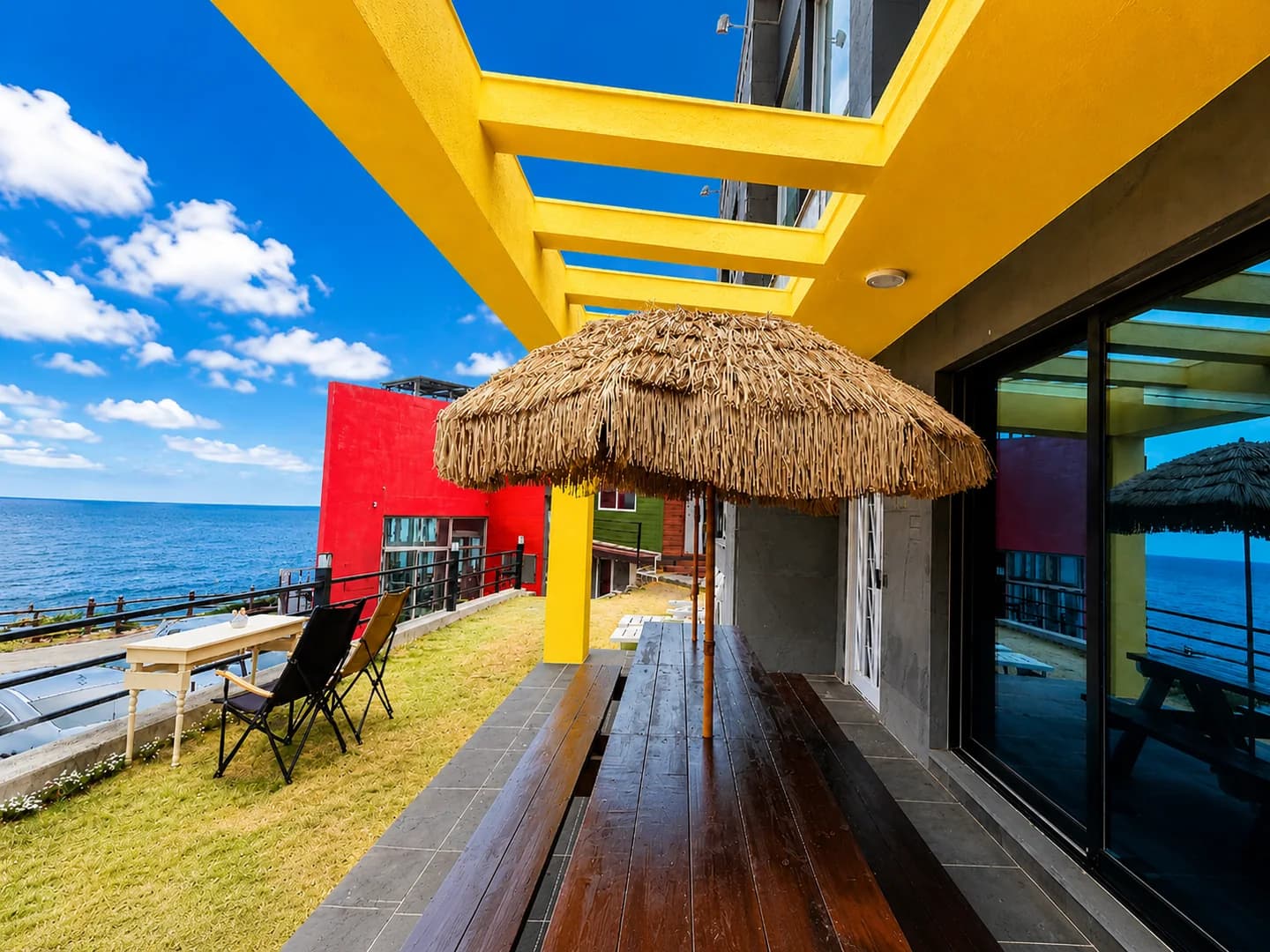 A yellow private patio facing the sea at the Witch’s Hill Jeju stay
