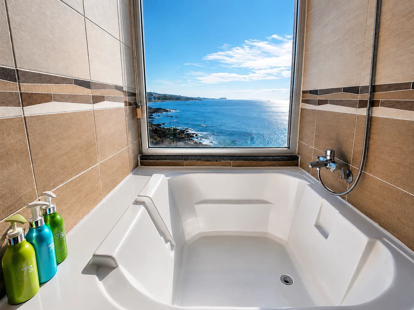 A bathtub beside a window overlooking the Jeju sea