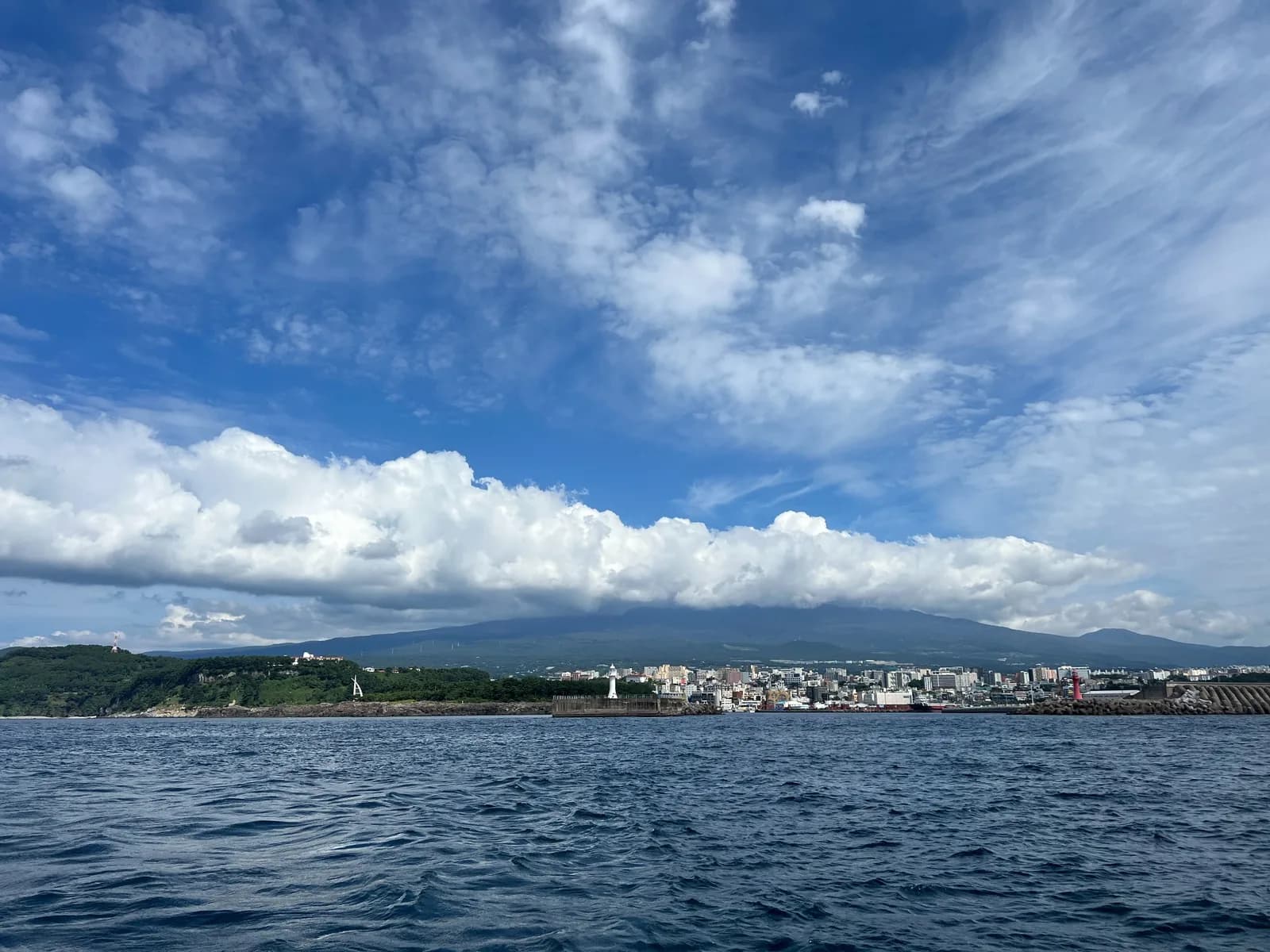 Seogwipo city and the mountains of inland Jeju seen from the sea