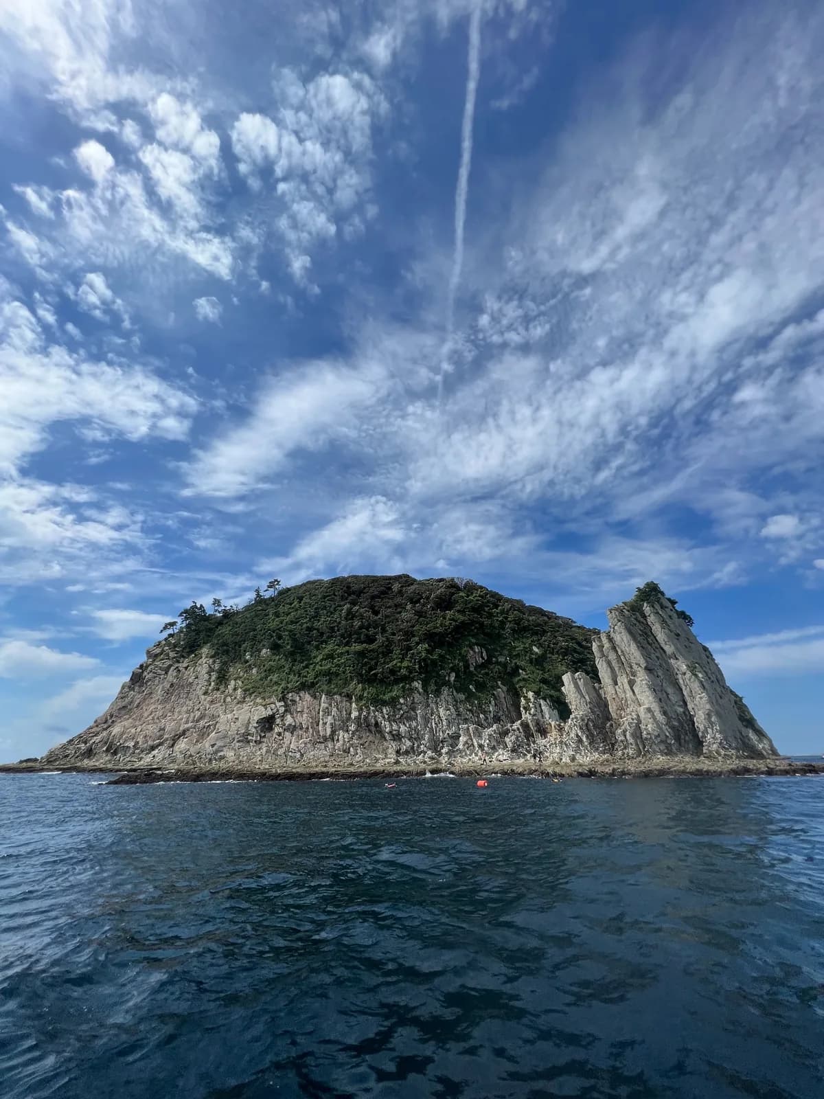 Steep cliffs and green vegetation on Munseom seen from the sea